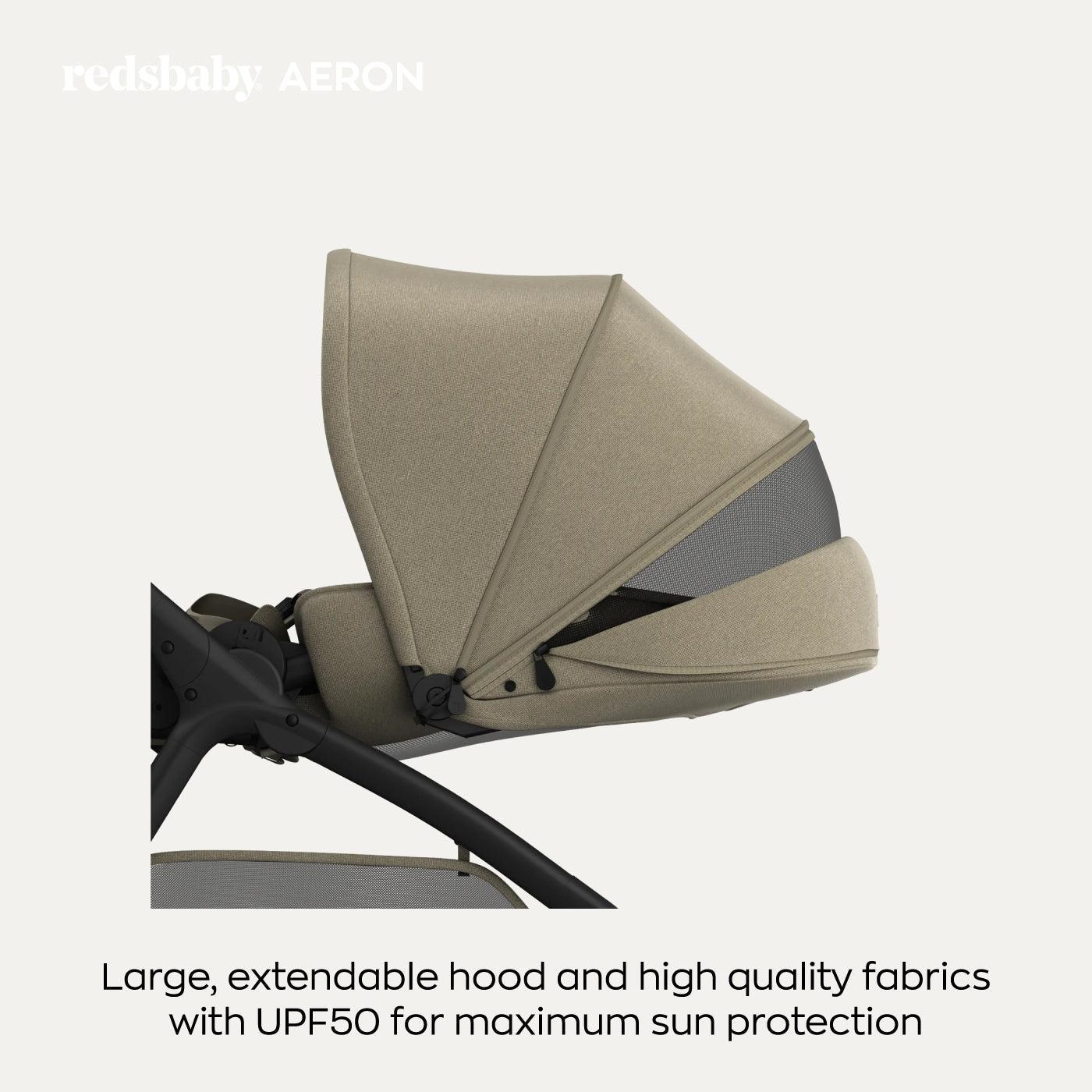 Close-up side view of the taupe-colored Redsbaby Aeron stroller with its large, extendable hood fully opened. The hood is made of high-quality fabrics with UPF50 for maximum sun protection. The text reads 'redsbaby AERON' at the top and 'Large, extendable hood and high quality fabrics with UPF50 for maximum sun protection' at the bottom. Close-up side view of the taupe-colored Redsbaby Aeron stroller with its large, extendable hood fully opened. The hood is made of high-quality fabrics with UPF50 for maximum sun protection. The text reads 'redsbaby AERON' at the top and 'Large, extendable hood and high quality fabrics with UPF50 for maximum sun protection' at the bottom.