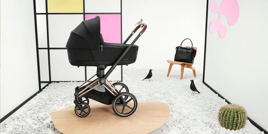 A sophisticated CYBEX Priam 4 stroller with a rosegold chassis and deep black carrycot stands prominently in a modern room with artistic decor, blending functionality with high-end design.