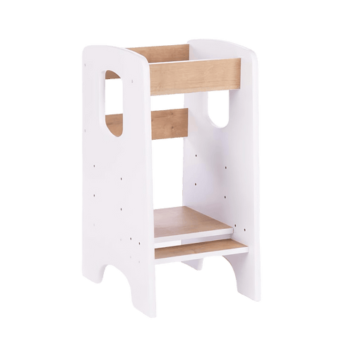A children's kitchen tower, also known as a kitchen helper stool, designed to allow a child to reach kitchen surfaces safely. The stool has a white frame with natural wood steps and rails, standing on a white background.
