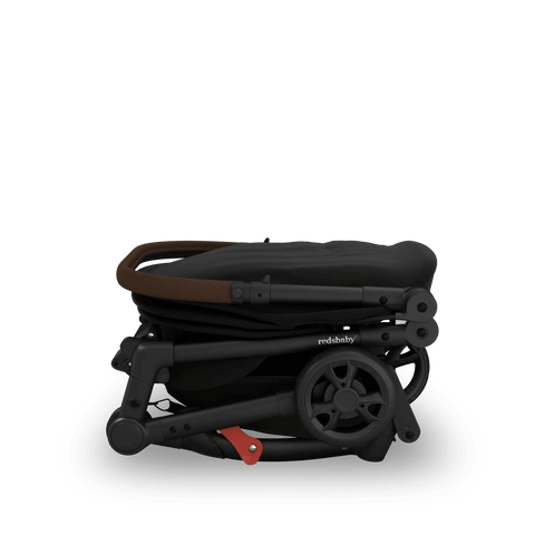 Side view of the Redsbaby SKIP² in black when folded, compact enough for travel storage.