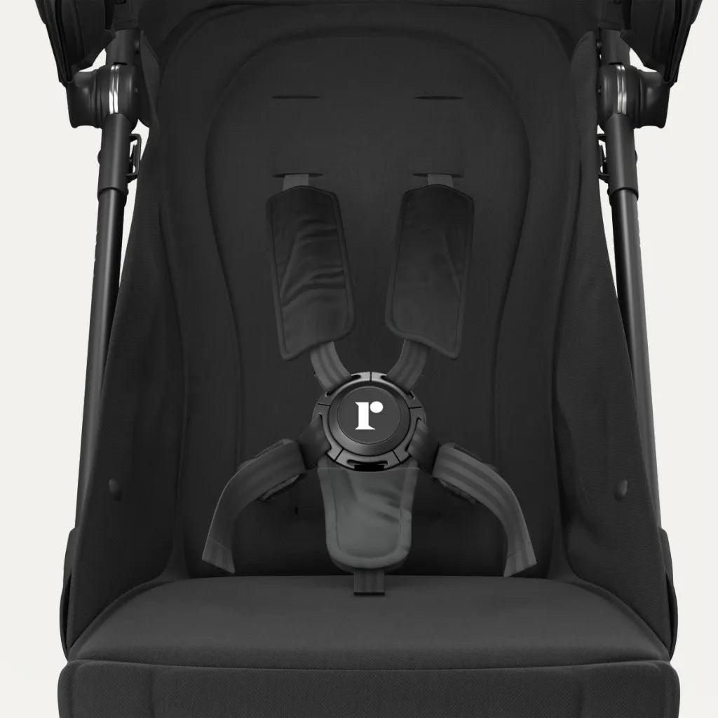 Close-up of Redsbaby SKIP²’s secure harness system in black, focusing on safety features.