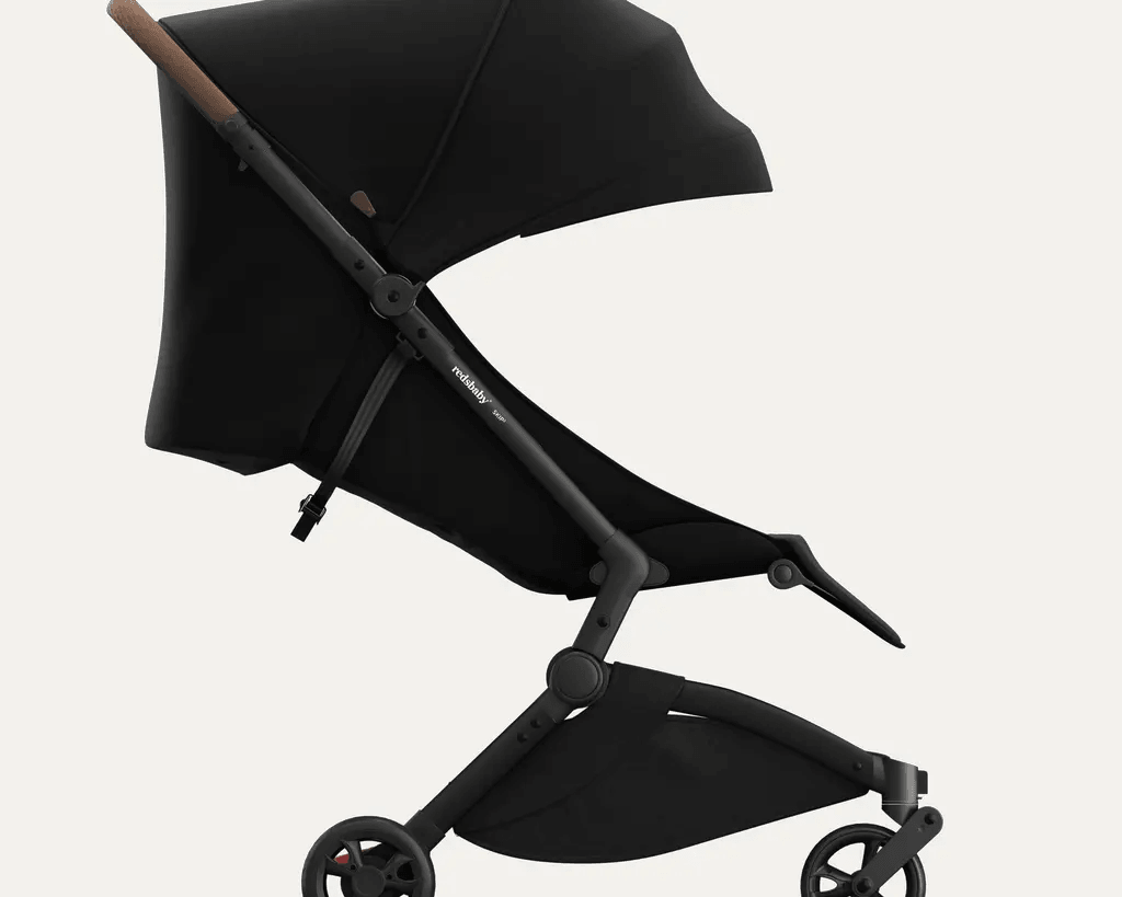 Side view of Redsbaby SKIP² stroller in black, fully reclined seat and raised footrest.