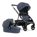 A side-by-side image of the Redsbaby NUVO stroller in blue slate color, featuring both the pram and bassinet attachments. The pram on the left has a sleek, ergonomic design with a curved handle and a reclining seat with a secure five-point harness system, while the bassinet on the right showcases a protective hood and a flat sleeping surface, both made with textured, high-quality fabric. The stroller demonstrates its versatility with easy-to-attach modules for different stages of a baby's development.