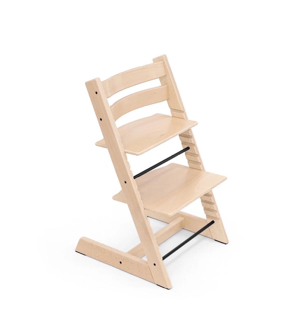 Stokke Tripp Trapp Chair in Natural wood colour, in front of a white backdrop