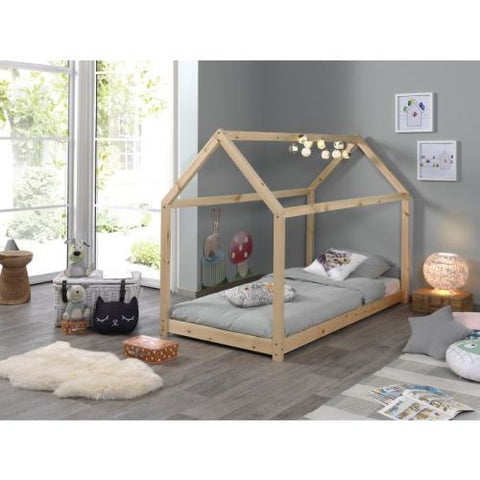 Children's room with a wooden house-shaped bed, toys, and decor.