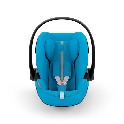 A CYBEX Cloud G car seat in Beach Blue Plus color, featuring an ergonomic design with a deep blue fabric cover, adjustable five-point safety harness with orange accents, a black shell, and a carry handle.
