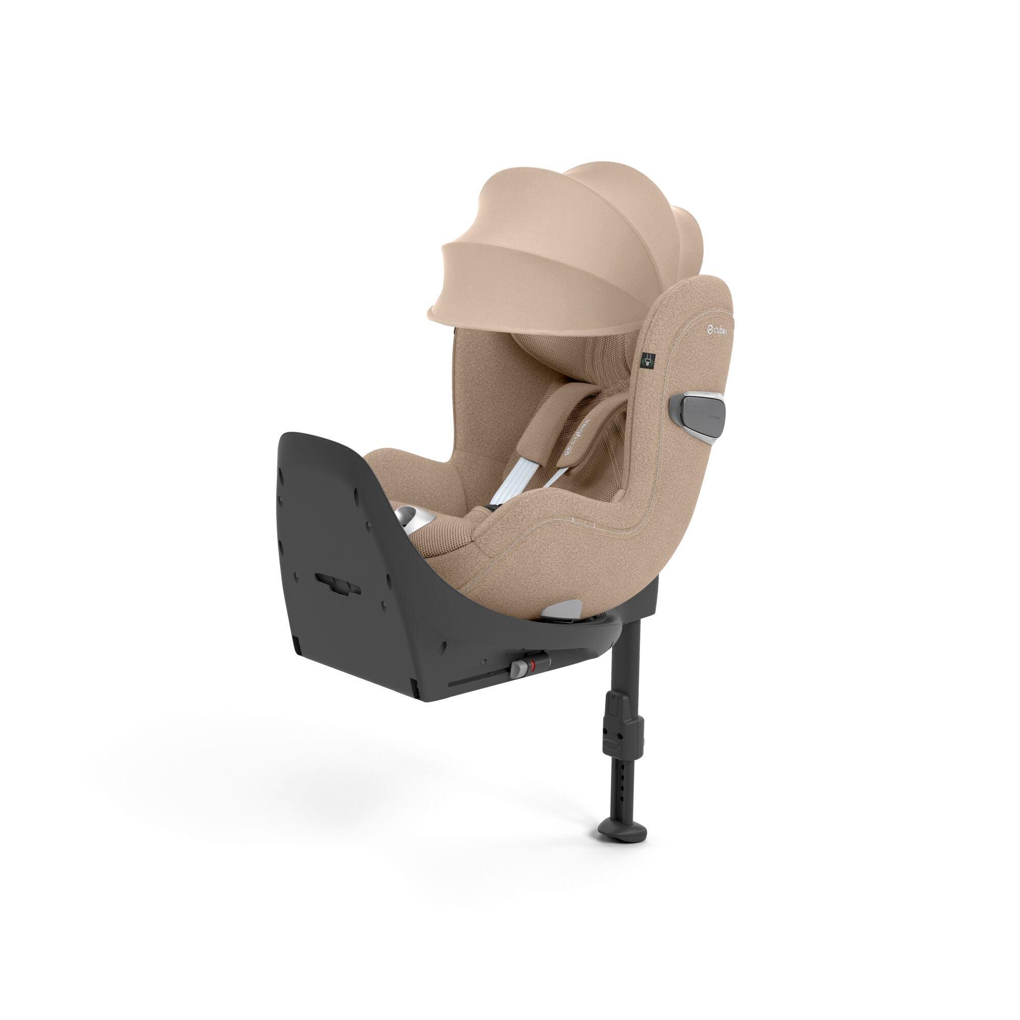 CYBEX Sirona T i-Size car seat in Cozy Beige, featuring a plush seat with an extendable sun canopy, safety harness, and an Isofix base with load leg for secure vehicle installation.